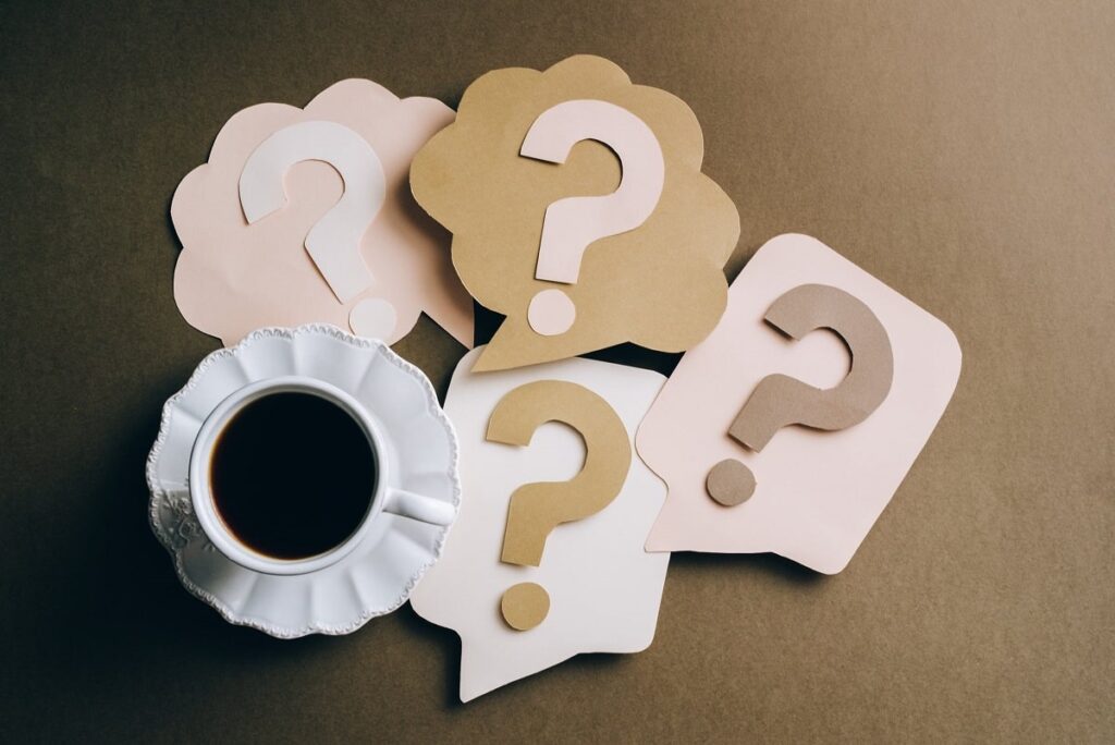 paper-questions-marks-next-to-a-cup-of-coffee