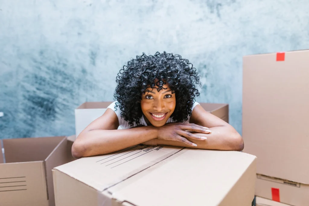 woman smiling leaned on a box